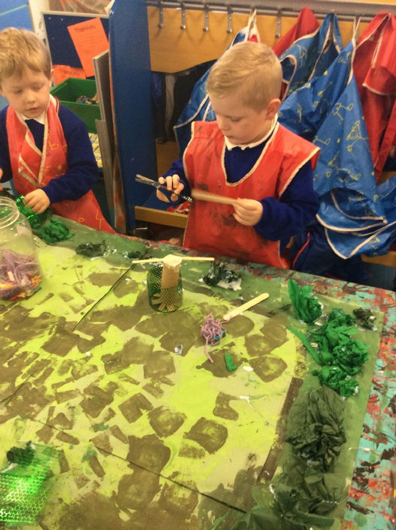 First, we mixed different shades of green paint to create our habitats base.
